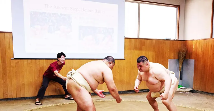 Live sumo sparring match in Osaka — visitors watch retired wrestlers compete then take a photo with a rikishi after the show